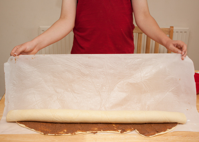 Rolling up the dough for cinnamon whirls