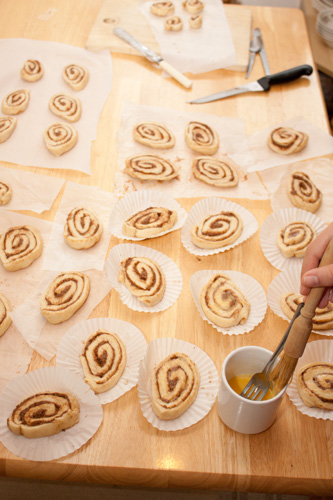 Glazing cinnamon whirls with egg